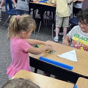 4th grade students making a craft with 1st grade students